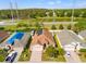 Aerial view of a home with solar panels, a lake view and well-maintained landscaping at 4247 Balmoral Ct, Wesley Chapel, FL 33543