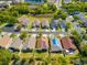 An aerial view of a suburban neighborhood with well-maintained lawns and a serene pond at 4247 Balmoral Ct, Wesley Chapel, FL 33543