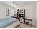 Relaxing bedroom featuring a ceiling fan, window with blinds, and a comfortable bed with a blue comforter at 4247 Balmoral Ct, Wesley Chapel, FL 33543