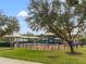 Playground with shade structures and play equipment surrounded by a black metal fence at 4247 Balmoral Ct, Wesley Chapel, FL 33543