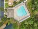 Overhead shot of the community pool with ample lounging space and a unique shape at 4247 Balmoral Ct, Wesley Chapel, FL 33543