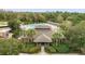 Aerial view of community pool and clubhouse surrounded by lush landscaping and mature trees at 4247 Balmoral Ct, Wesley Chapel, FL 33543