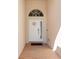Inviting entryway with a decorative front door, transom window and brick-paved porch at 4247 Balmoral Ct, Wesley Chapel, FL 33543