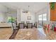 Open kitchen view into the dining room with a chandelier, decorative wall niche, and sunlit living room at 4247 Balmoral Ct, Wesley Chapel, FL 33543
