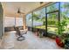 Relaxing screened lanai with tiled floors and ceiling fan, overlooking the backyard at 4247 Balmoral Ct, Wesley Chapel, FL 33543