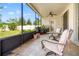 Relaxing screened lanai with furniture, overlooking the backyard at 4247 Balmoral Ct, Wesley Chapel, FL 33543