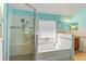 Stunning bathroom featuring a garden tub with shower, and designer tiling at 4247 Balmoral Ct, Wesley Chapel, FL 33543