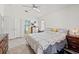 Comfortable main bedroom featuring tiled floors, a ceiling fan, and direct access to the attached bath at 4247 Balmoral Ct, Wesley Chapel, FL 33543