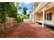 Spacious backyard featuring a two-story home with a covered patio and mature trees at 441 Lucerne Ave, Tampa, FL 33606