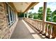 Large tiled balcony with decorative columns and lush greenery in the background at 441 Lucerne Ave, Tampa, FL 33606