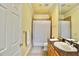 Well-lit bathroom featuring tiled floor, a single sink vanity, and a shower with a patterned curtain at 441 Lucerne Ave, Tampa, FL 33606