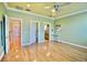Spacious bedroom showing a view of a hallway, attached bathroom, and sports equipment adorning the floor at 441 Lucerne Ave, Tampa, FL 33606