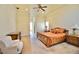 Primary bedroom with soft carpet, tray ceiling, and traditional furnishings at 441 Lucerne Ave, Tampa, FL 33606