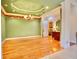 Formal dining room featuring hardwood floors, a decorative chandelier, and a view of the kitchen at 441 Lucerne Ave, Tampa, FL 33606