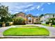 Expansive brick home with grand entrance, lush landscaping, and circular driveway at 441 Lucerne Ave, Tampa, FL 33606