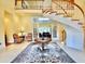 Bright foyer featuring a spiral staircase, a high ceiling, marble floors, and a decorative rug with vintage armchairs at 441 Lucerne Ave, Tampa, FL 33606