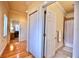 Bright hallway featuring hardwood floors, closet, and doorways to the bath and bedroom at 441 Lucerne Ave, Tampa, FL 33606