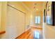Bright hallway with hardwood floors, crown molding, closet doors, and a decorative art piece at 441 Lucerne Ave, Tampa, FL 33606