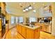 Open kitchen featuring an island, stainless steel appliances, and natural wood flooring at 441 Lucerne Ave, Tampa, FL 33606