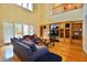 Open living space with wood floors, high ceilings, and large windows at 441 Lucerne Ave, Tampa, FL 33606