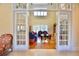 View of the living room, which features hardwood floors, a tall ceiling and large windows at 441 Lucerne Ave, Tampa, FL 33606