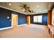 Large media room with custom shelving, a projector, and plush carpeting for a comfortable experience at 441 Lucerne Ave, Tampa, FL 33606