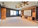 Spacious media room with custom built-ins, a projector screen, and neutral carpet at 441 Lucerne Ave, Tampa, FL 33606