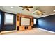 Home theater room showcasing custom media cabinetry, a projector screen, and comfortable carpeting at 441 Lucerne Ave, Tampa, FL 33606