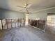 Open-concept living room with tile floors and ceiling fan offering renovation potential at 5012 Osprey Ln, New Port Richey, FL 34652