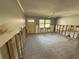 Spacious living room with tiled floor, large window, and ceiling fan, ready for renovation at 5012 Osprey Ln, New Port Richey, FL 34652