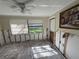 Sunlit room with tile floors and a large window, offering potential for renovation at 5012 Osprey Ln, New Port Richey, FL 34652