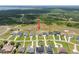 Aerial shot of homes in a neighborhood that backs up to a field, that has some trees and clearings at 5214 Lake Venice Dr, Wimauma, FL 33598
