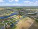 Aerial view showcases a waterfront community with beautiful waterways, lush landscaping, and plenty of sunshine at 5214 Lake Venice Dr, Wimauma, FL 33598