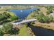 Breathtaking aerial view showcasing a serene community with a fountain lake and lush green landscapes at 5214 Lake Venice Dr, Wimauma, FL 33598