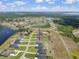 Stunning aerial view of waterfront community featuring meticulously landscaped lawns and access to the lake at 5214 Lake Venice Dr, Wimauma, FL 33598