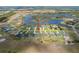 Aerial view of homes that are waterfront properties in an area surrounded by bodies of water at 5214 Lake Venice Dr, Wimauma, FL 33598