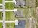 An aerial view showcases the home nestled in a neighborhood, and includes a pool for one of the homes at 5214 Lake Venice Dr, Wimauma, FL 33598