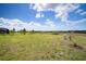 Large backyard with green grass, and utility access panels placed sporadically throughout at 5214 Lake Venice Dr, Wimauma, FL 33598
