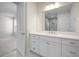 Bright bathroom boasts white cabinetry, quartz counters, undermount sink, and a large mirror at 5214 Lake Venice Dr, Wimauma, FL 33598