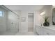 Bright bathroom featuring glass enclosed shower, dual sink vanity, and walk in closet at 5214 Lake Venice Dr, Wimauma, FL 33598