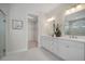 Bright bathroom featuring dual sink vanity, walk-in closet, and tiled floors at 5214 Lake Venice Dr, Wimauma, FL 33598