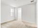 Bright bedroom with neutral carpet and a window overlooking the side yard at 5214 Lake Venice Dr, Wimauma, FL 33598