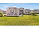 Charming home with lush lawn and lovely landscaping, enhanced by gray shutters and a covered front entry at 5214 Lake Venice Dr, Wimauma, FL 33598