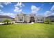 Charming one-story home featuring lush lawn and attractive landscaping at 5214 Lake Venice Dr, Wimauma, FL 33598