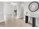 Bright foyer with wood floors, decorative mirror, console table, and open doorways at 5214 Lake Venice Dr, Wimauma, FL 33598