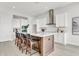 Well-equipped kitchen featuring a center island with seating, white cabinetry, and modern fixtures at 5214 Lake Venice Dr, Wimauma, FL 33598