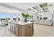 Bright, open kitchen with a large island, stainless steel appliances, and coffered ceiling at 5214 Lake Venice Dr, Wimauma, FL 33598