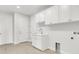 Well-organized laundry room with ample cabinet space, a utility sink, and hookups for laundry machines at 5214 Lake Venice Dr, Wimauma, FL 33598