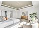 Serene main bedroom with a tray ceiling, stylish furniture, and relaxing atmosphere at 5214 Lake Venice Dr, Wimauma, FL 33598