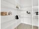 Organized walk-in pantry with white wire shelving, ample storage for kitchen essentials at 5214 Lake Venice Dr, Wimauma, FL 33598
